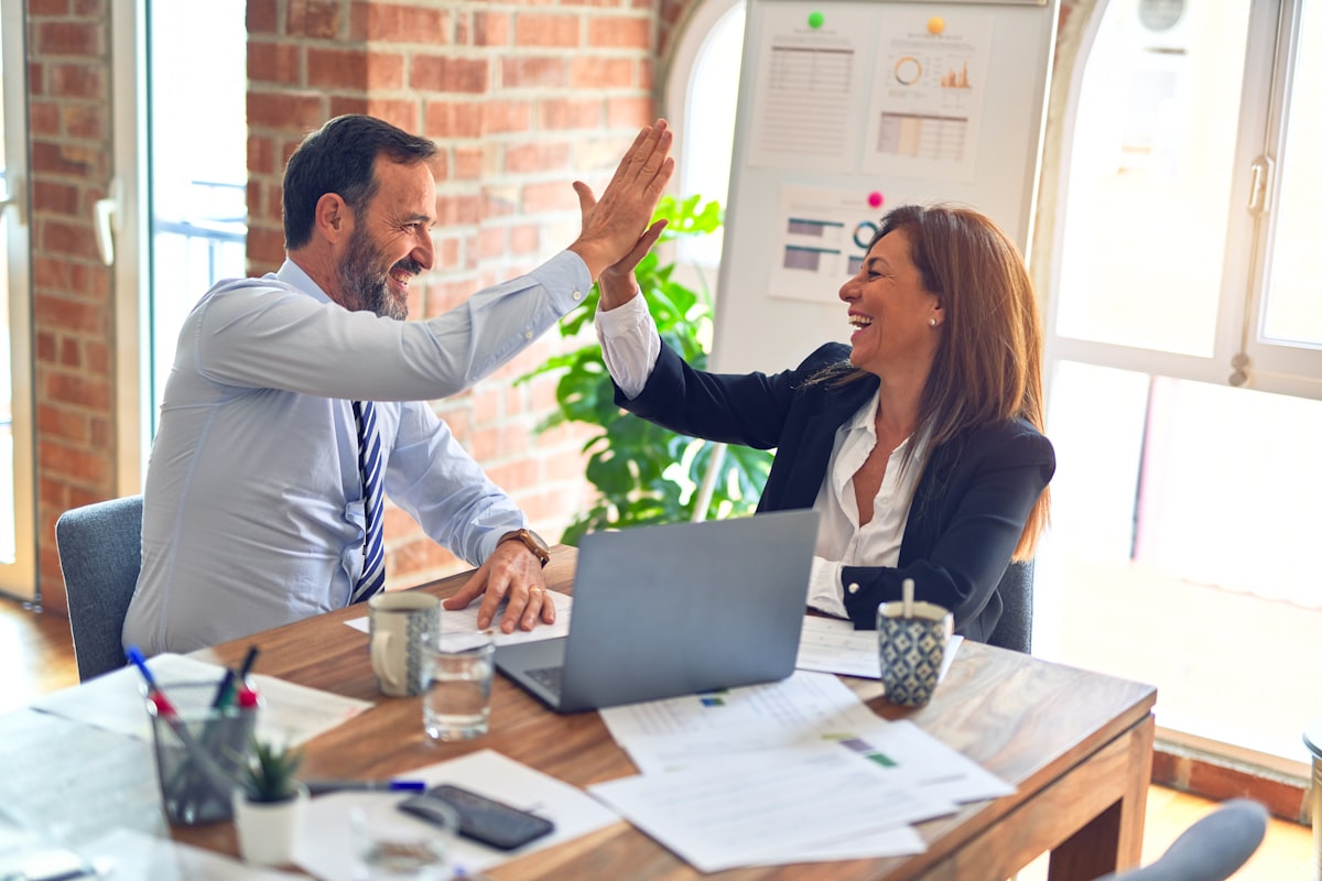 Colleagues celebrating a high five together